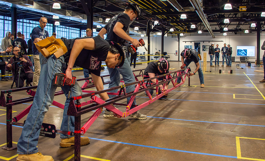 a large group of people work with tools inside