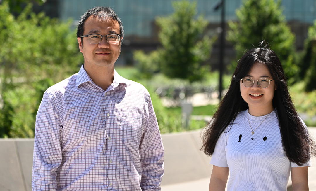 two individuals standing outside smiling at camera